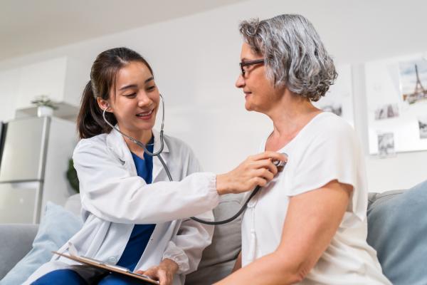 Dr. checks woman's heart rate