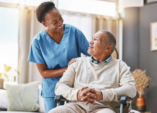 Nurse helps patient in wheelchair
